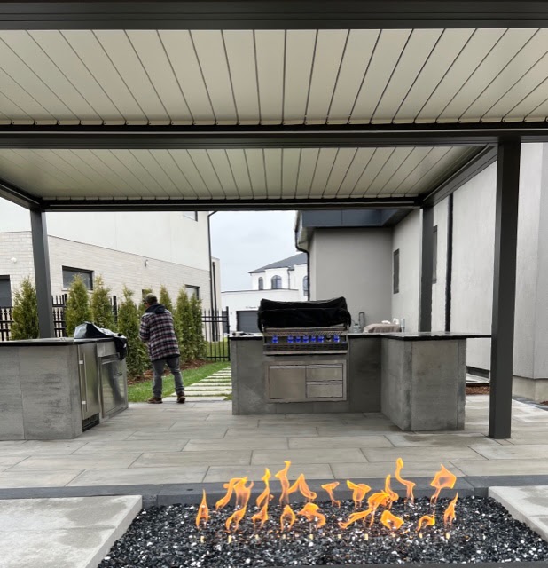outdoor kitchen with pergola, custom cabinets, bbq, fire feature, paving